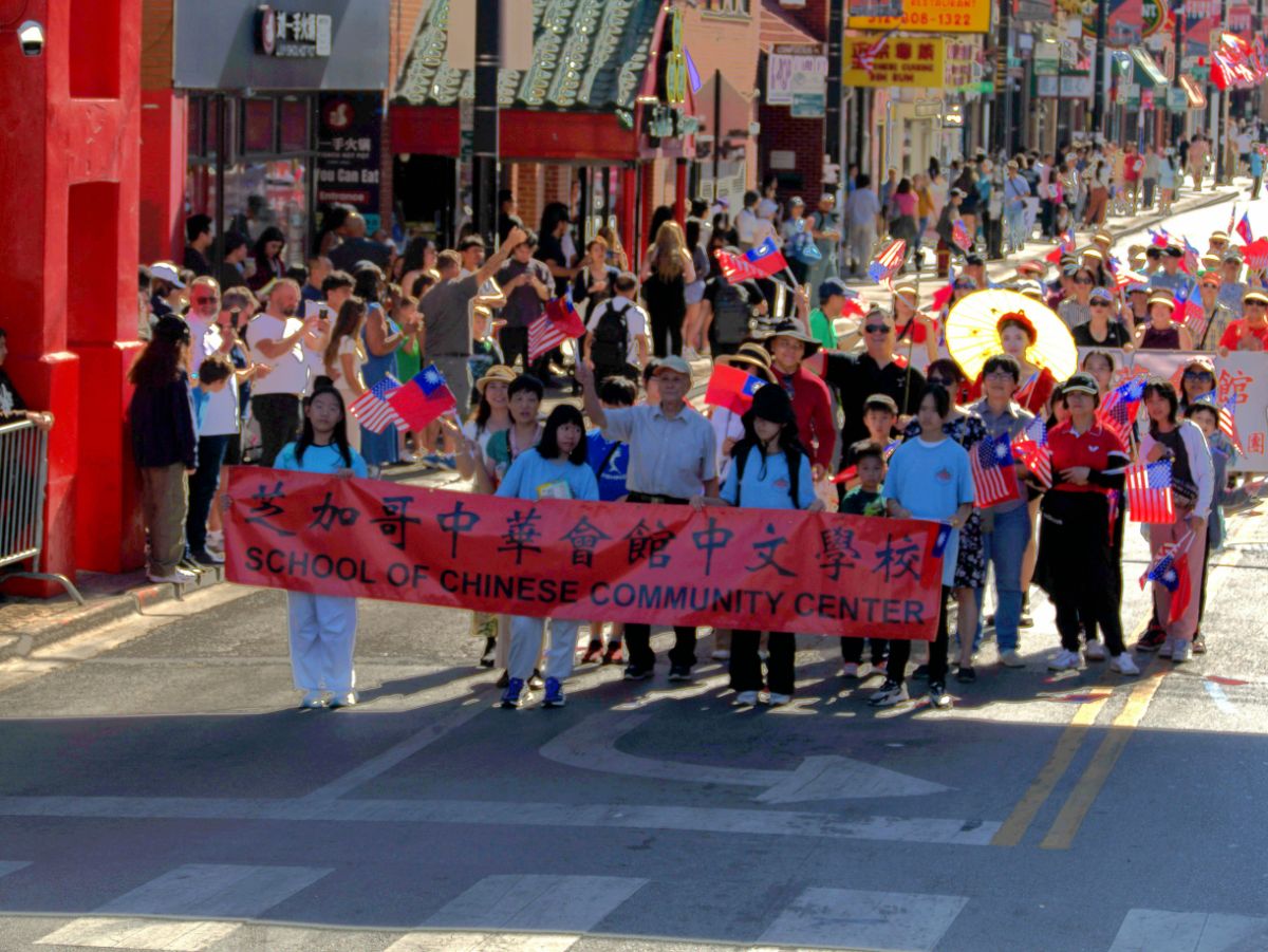 Chinese school students marching with the CCBA banner